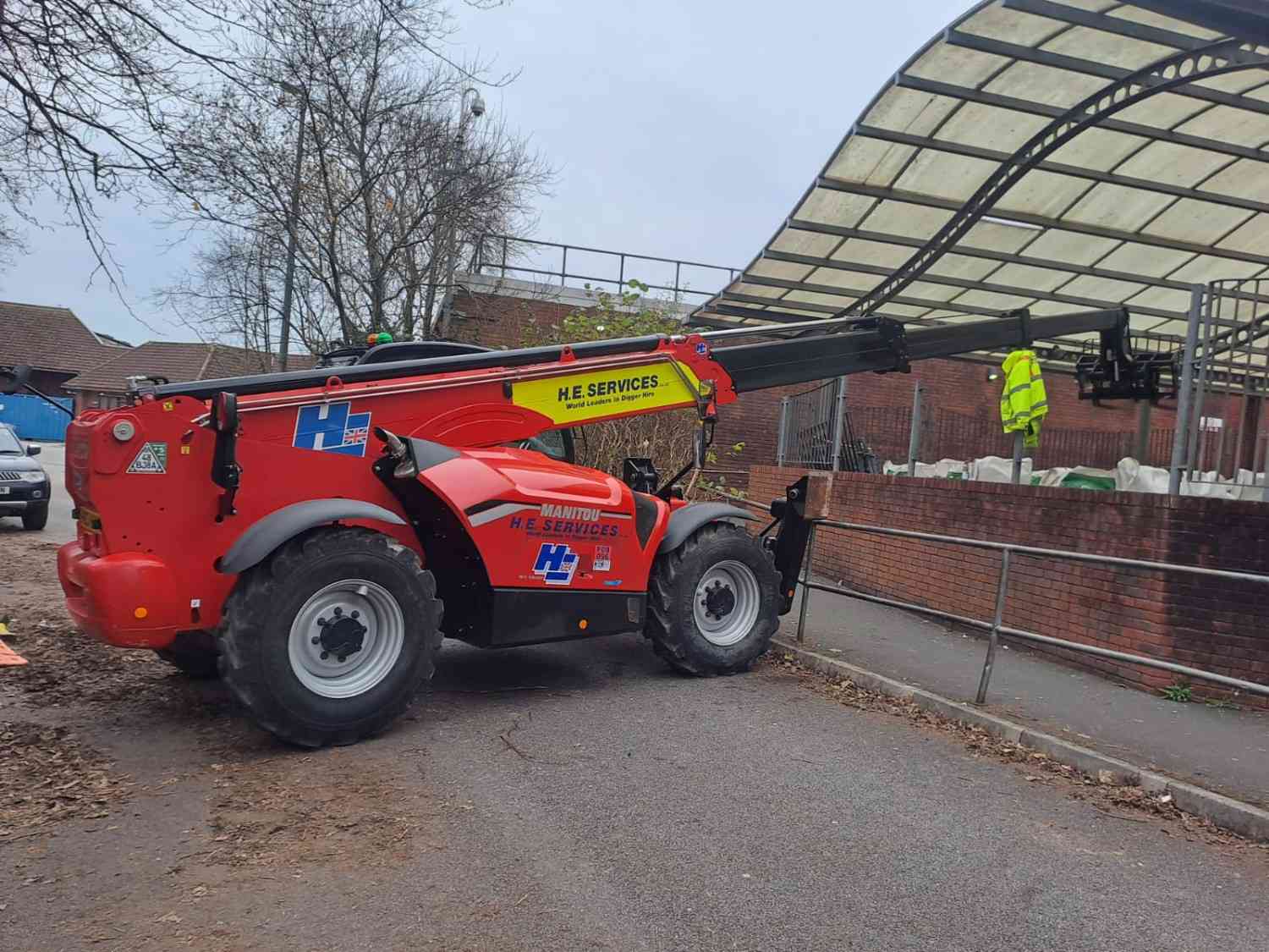 Telehandler working on landscaping at a commercial building entrance